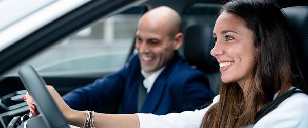 woman and man driving a car
