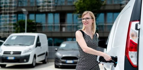 Woman charging white van