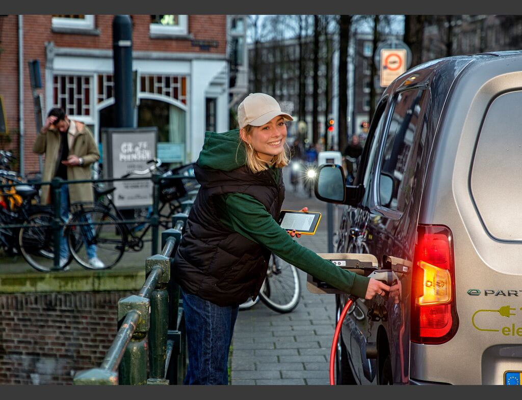 Woman with cap charging van