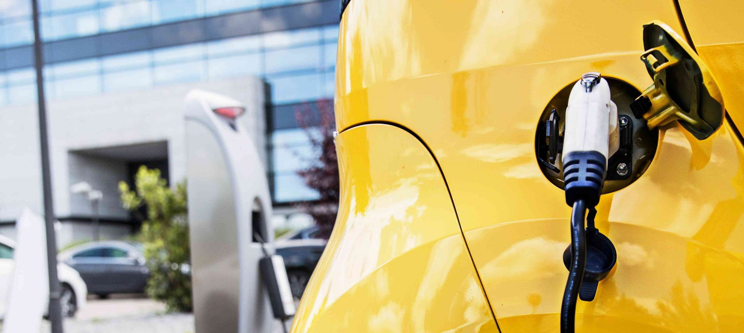 Yellow-PHEV-plugged-in-and-charging-at-office-scaled