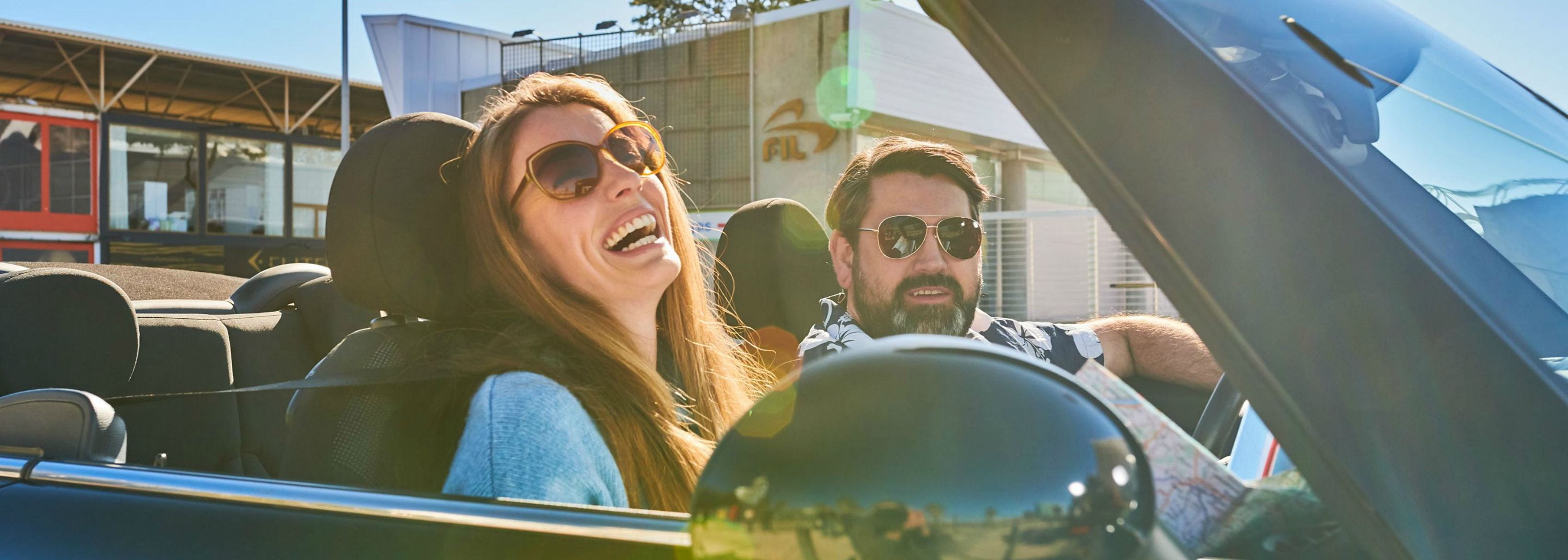 Happy woman and man in a car