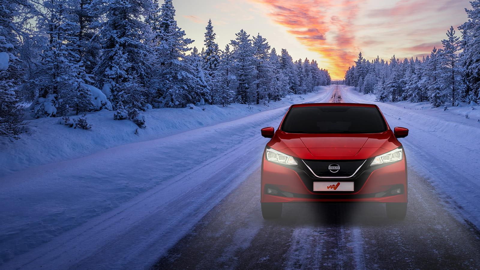 red car driving on a road with snow