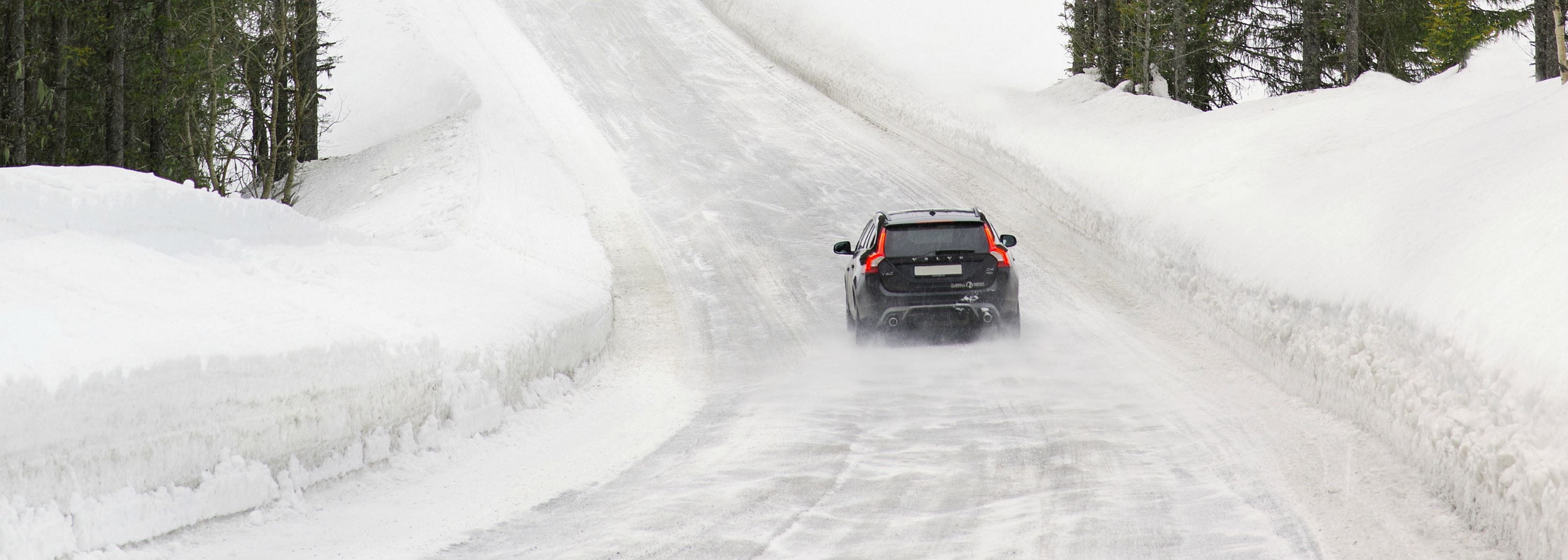 Car driving on road with snow