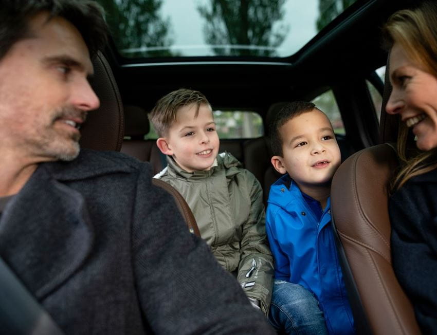 A man, a woman and 2 children inside a car