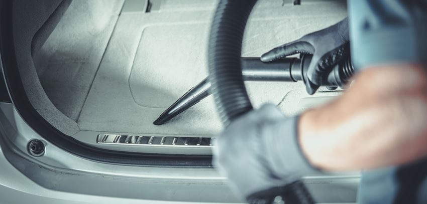 man vacuuming car cropped