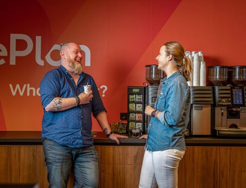 Man and woman chatting in the coffee corner
