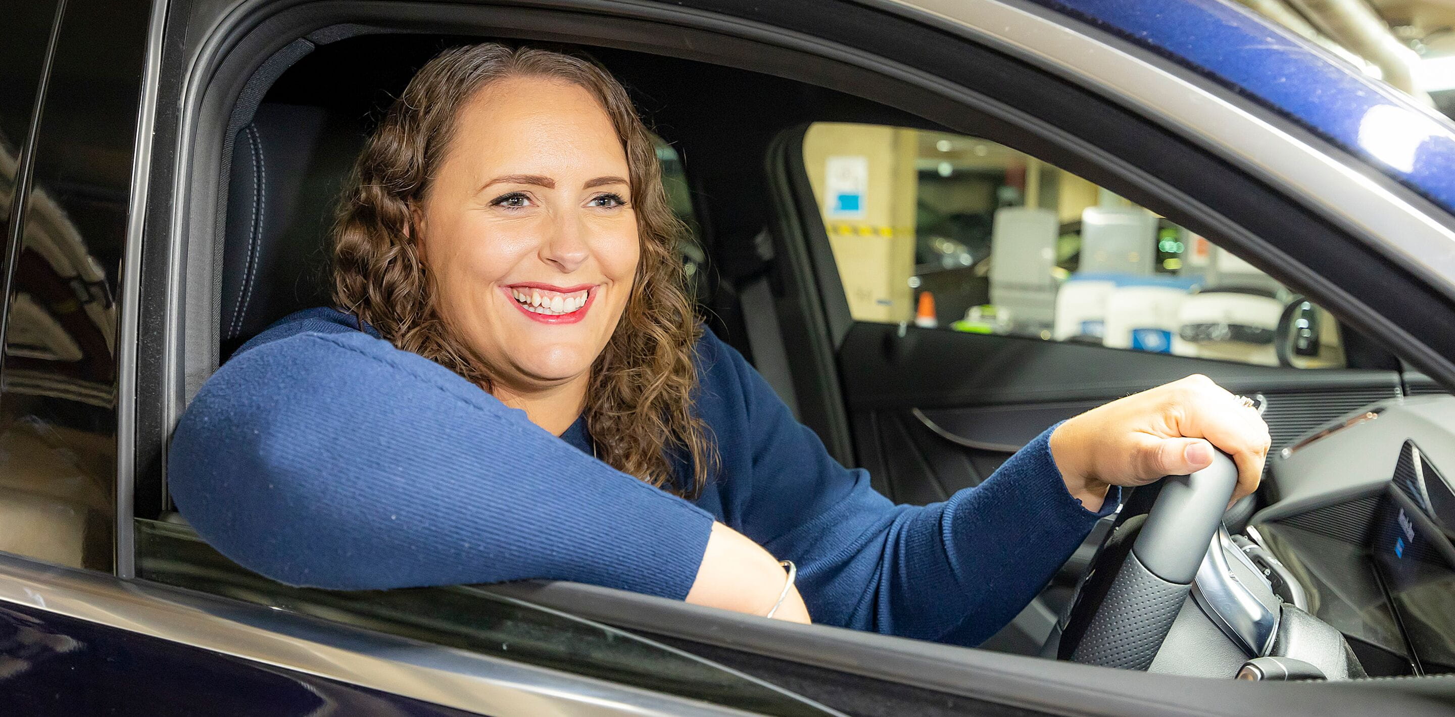 Woman in the car smiling