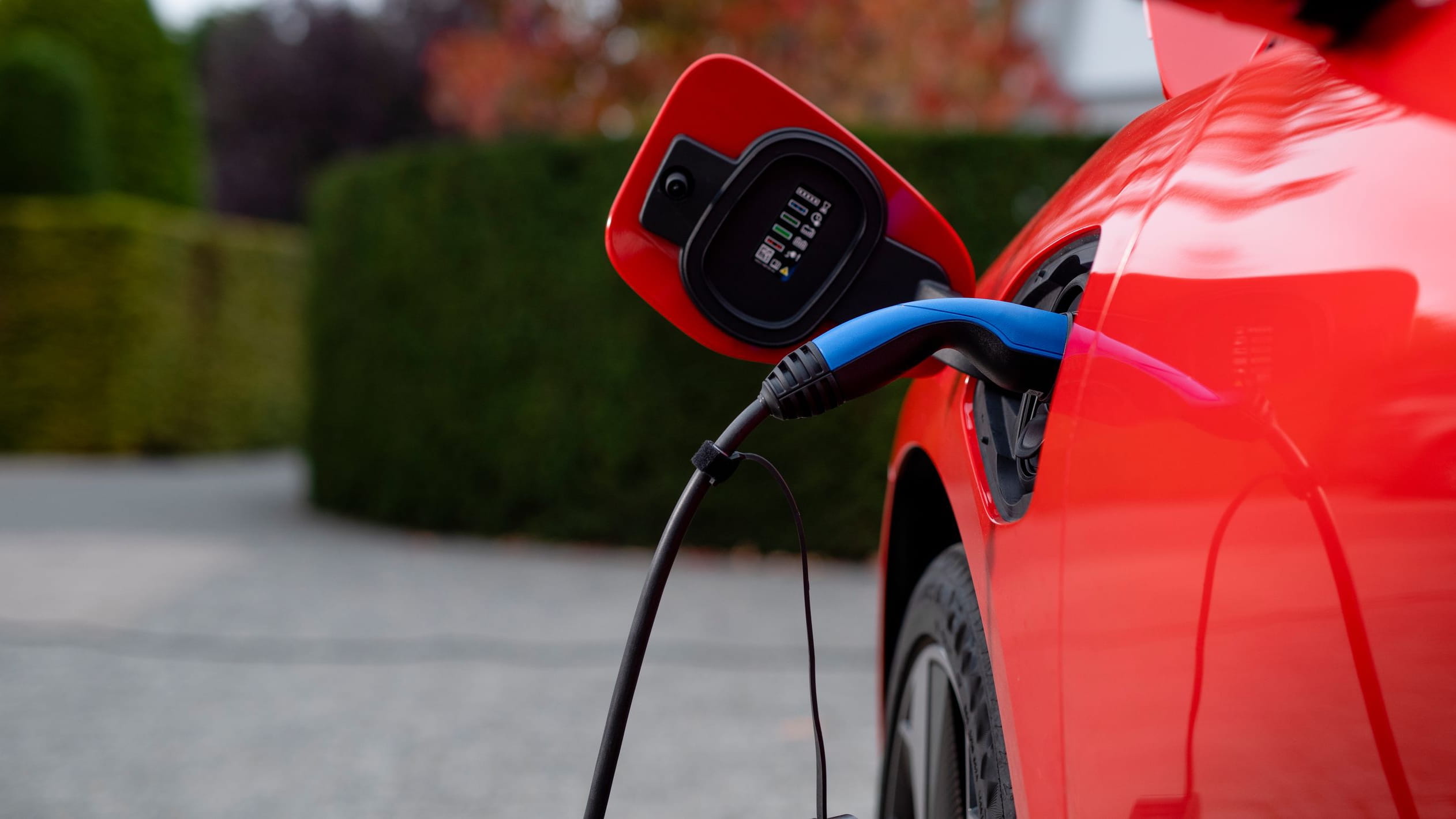 Red EV getting charged