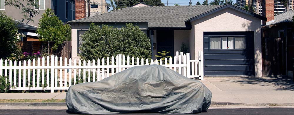 covered car on street - cropped