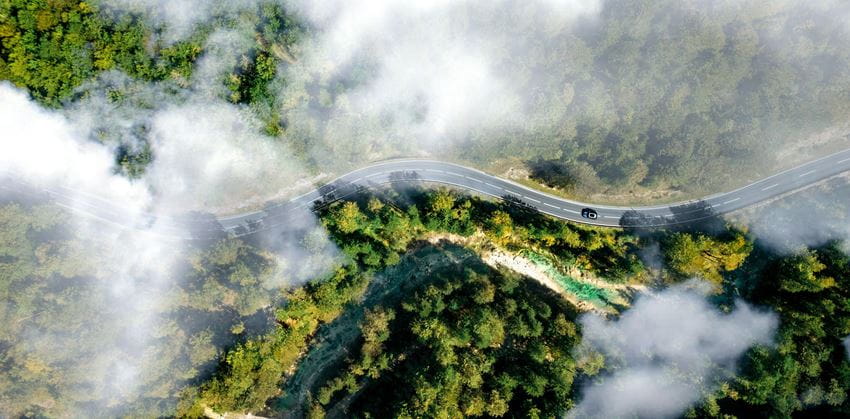 Aerial shot - curvy road with clouds