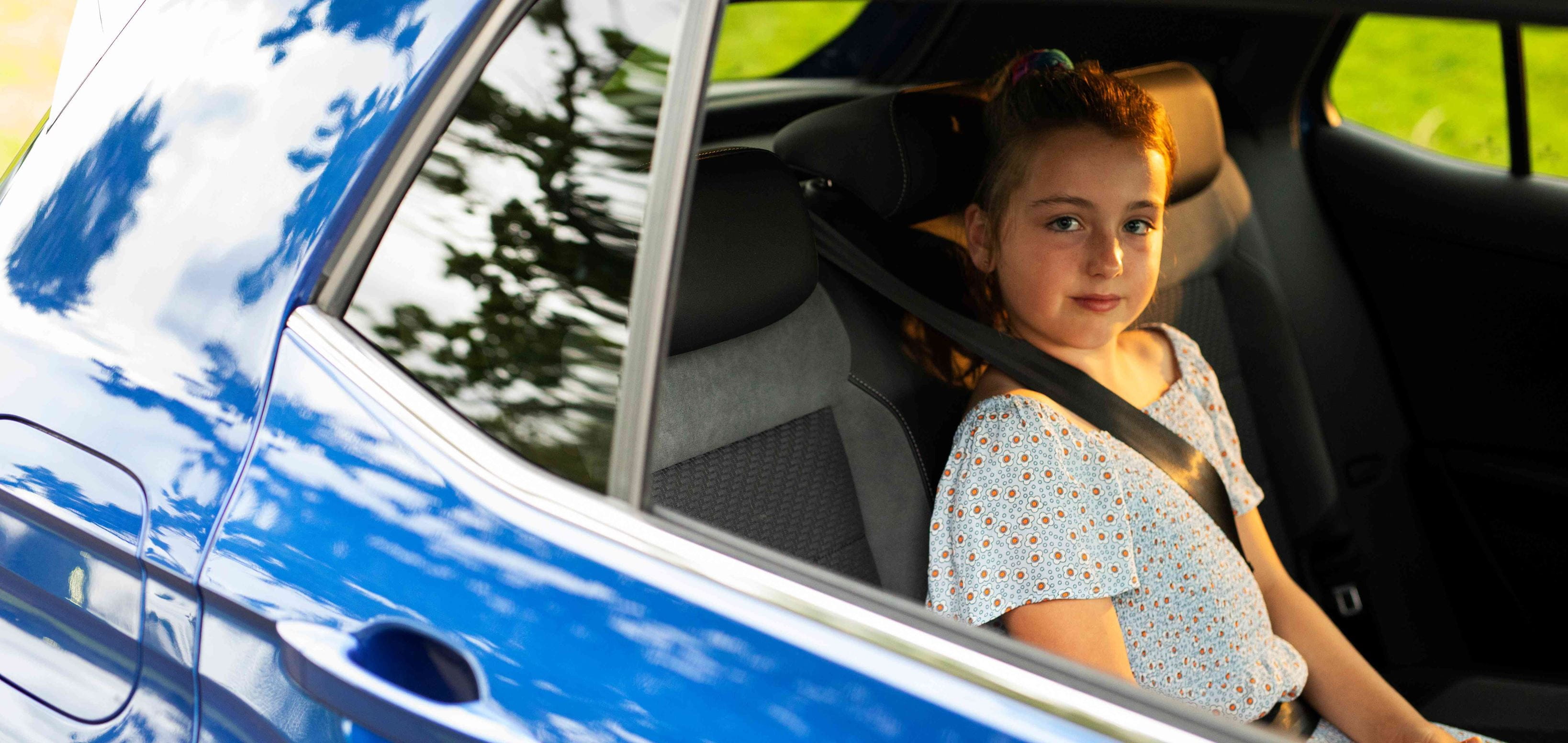 Child sitting in back seat of car