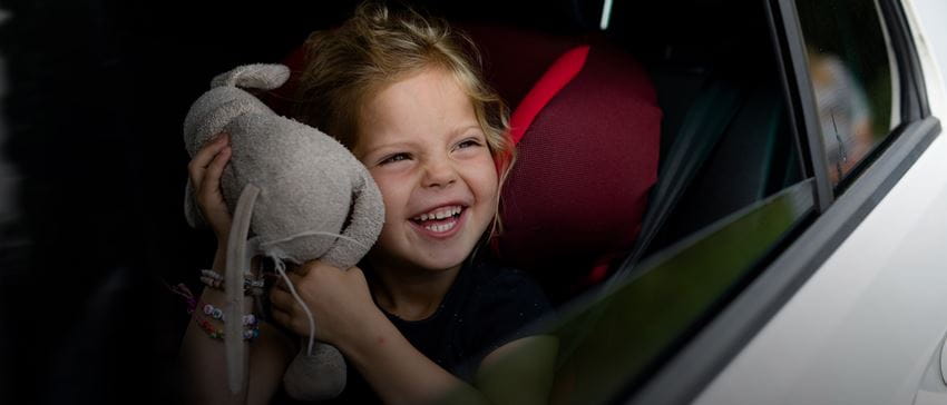 Close up - child in car with toy