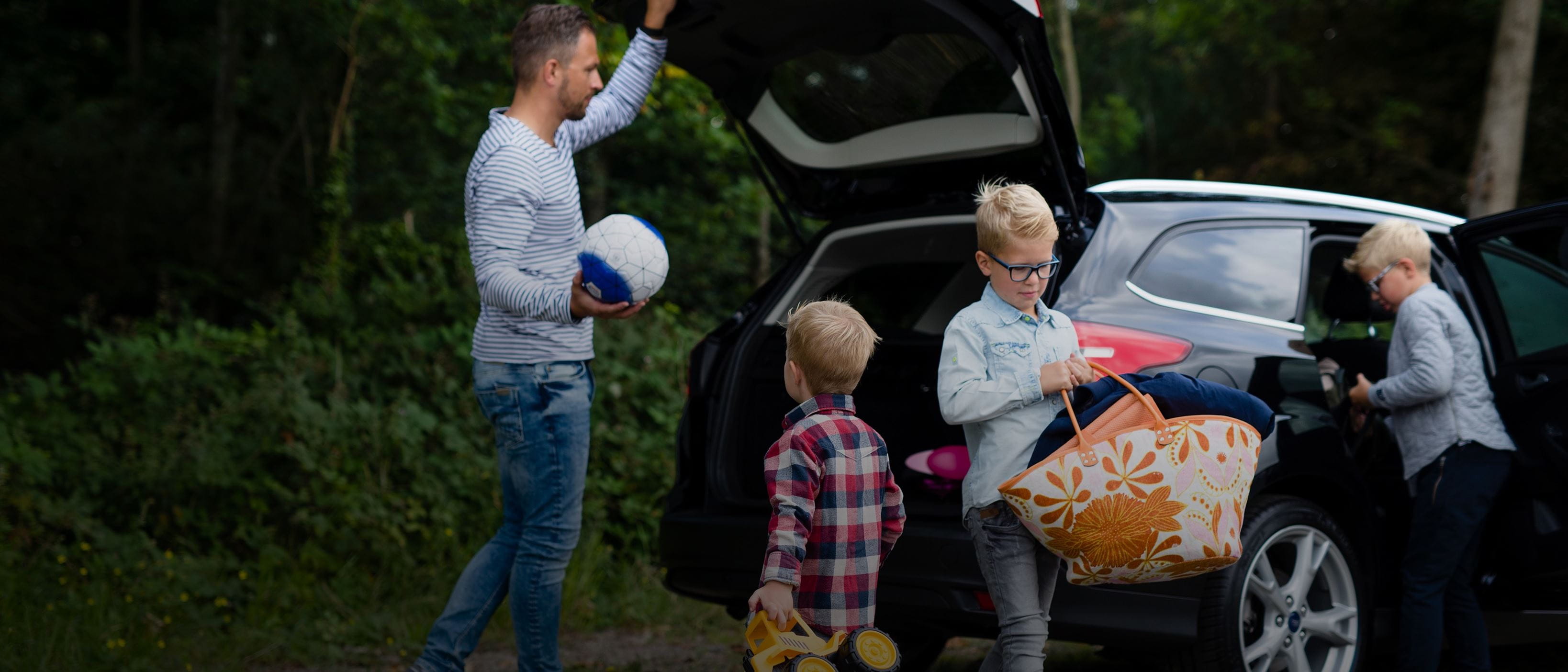 Family taking things out of car