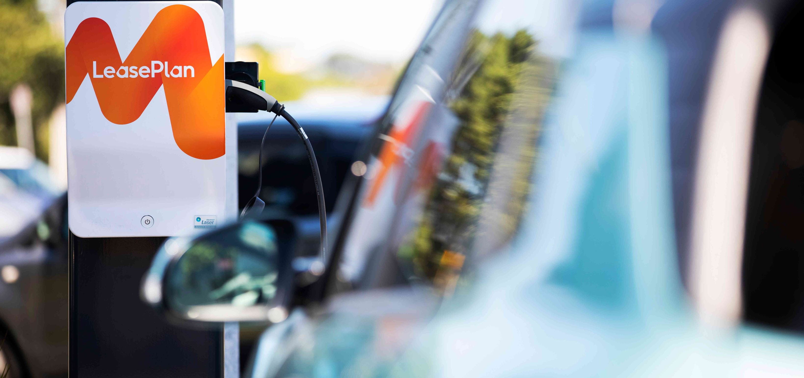 Car plugged into a LeasePlan branded charger