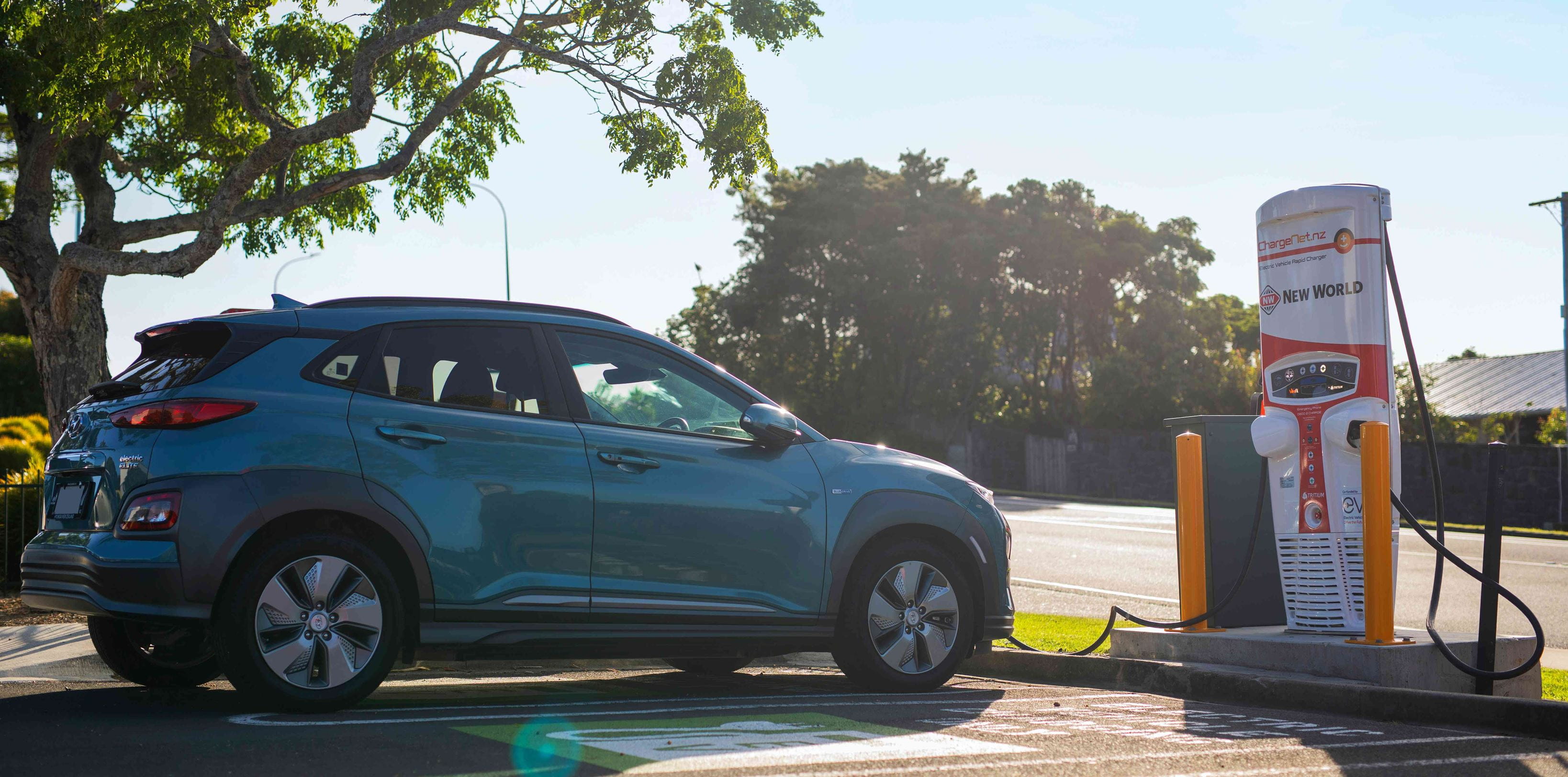 Electric vehicle at the charging station plugged into EV charger