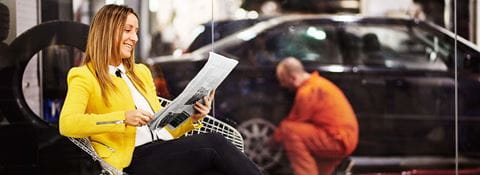 Mechanic working and person waiting in room