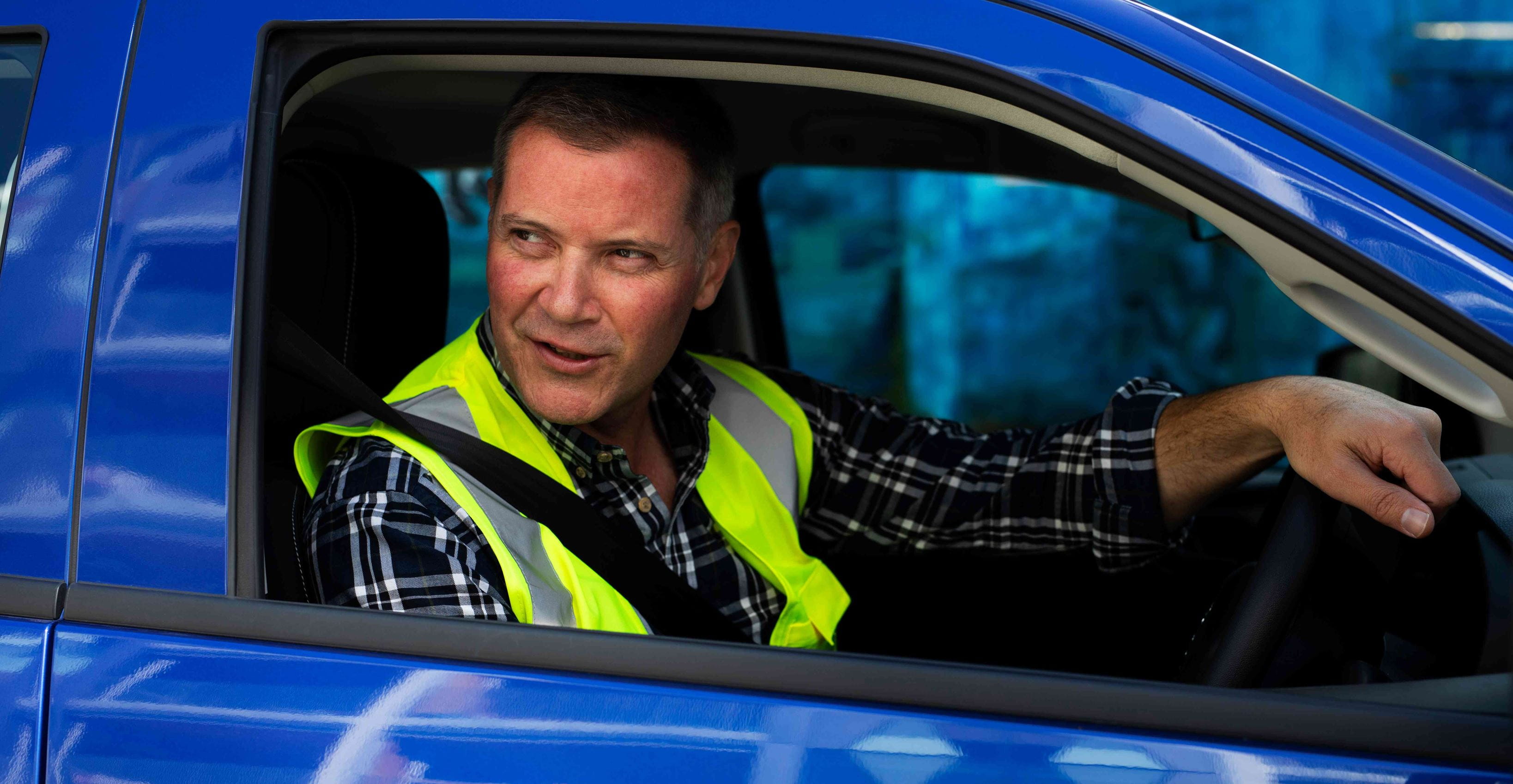 Close up- the man behind the wheel - blue car