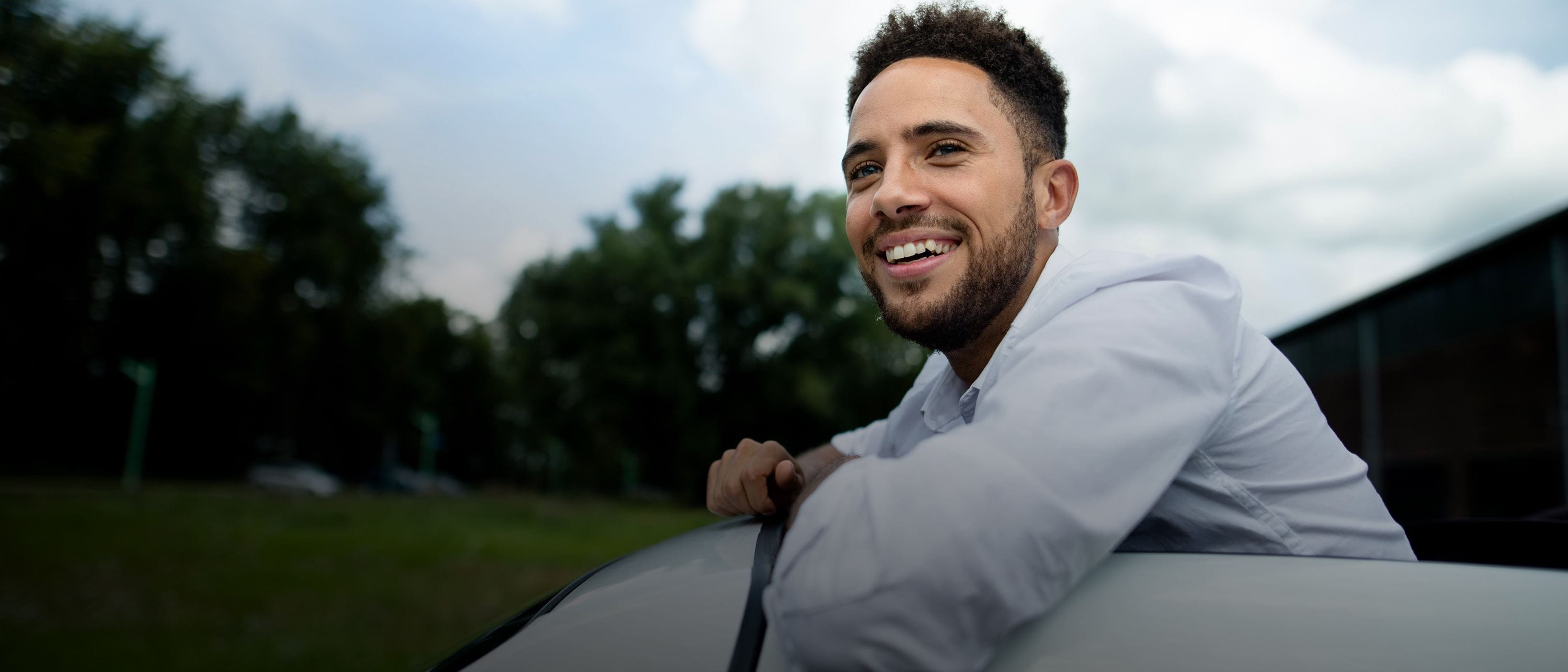 Man leaning out of sunroof - space to the left