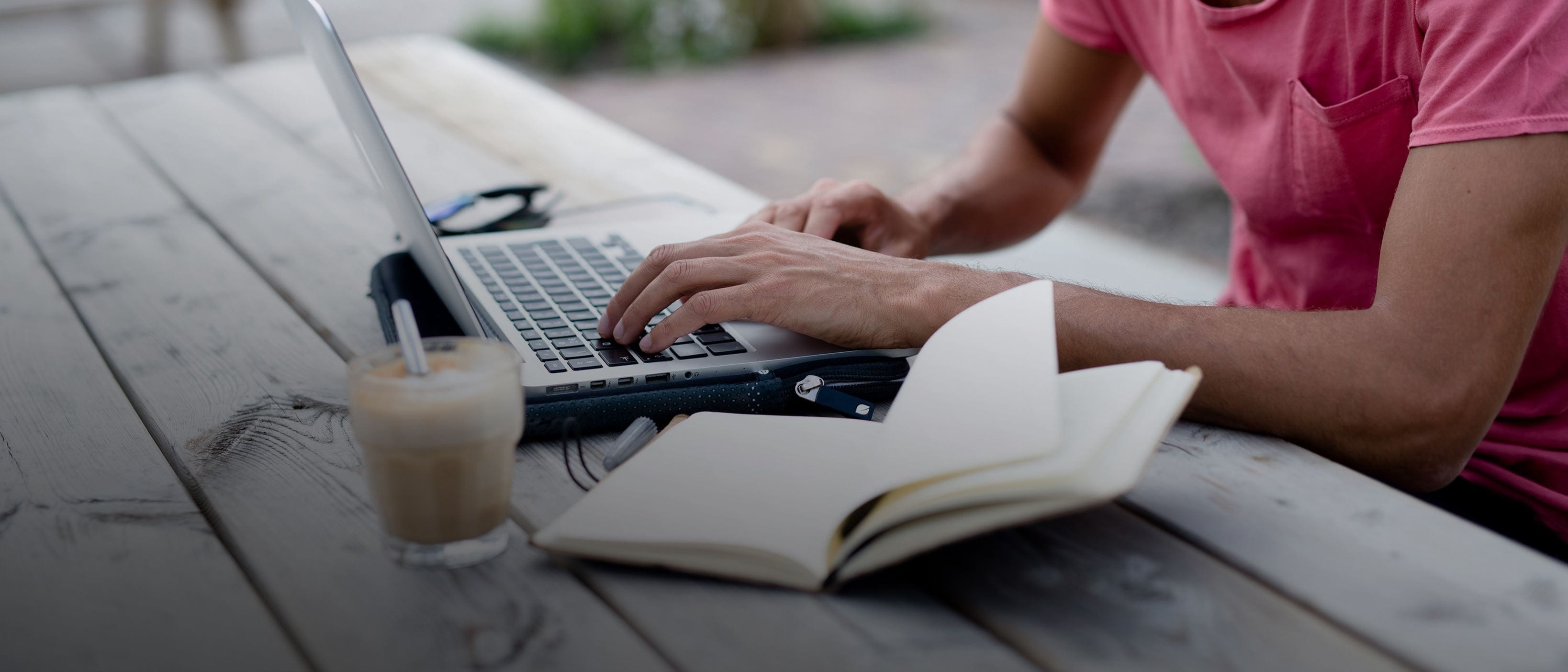 Male hands typing on a laptop