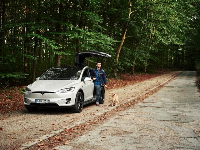 Men with car and dog